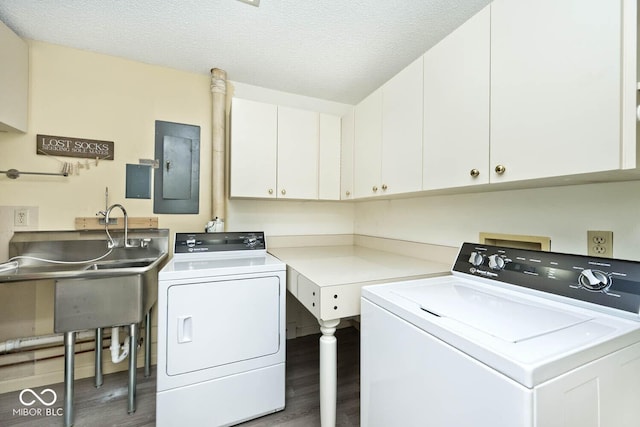 washroom with electric panel, washer and dryer, wood finished floors, cabinet space, and a textured ceiling