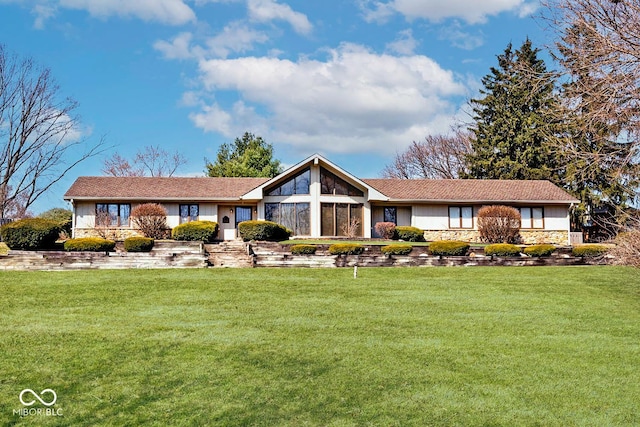 view of front of house featuring a front lawn and stone siding