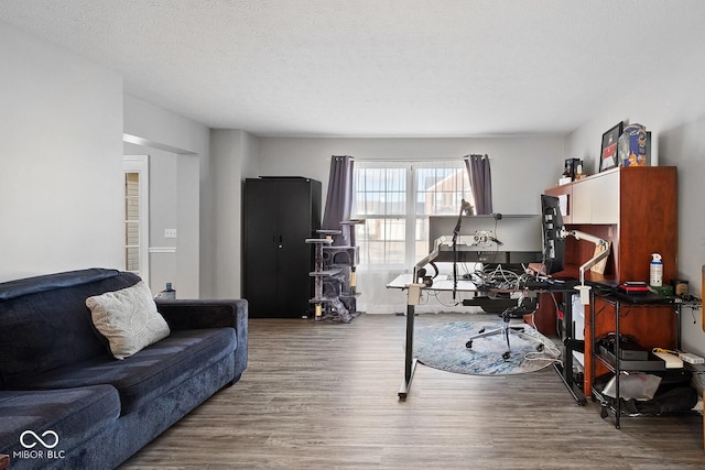 office space with wood finished floors and a textured ceiling