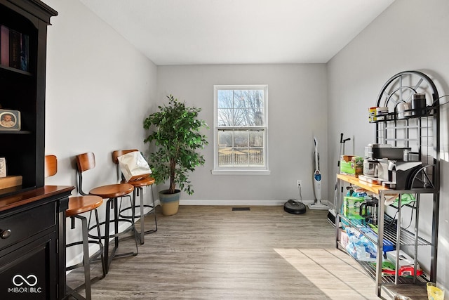 interior space with visible vents, light wood-style flooring, and baseboards