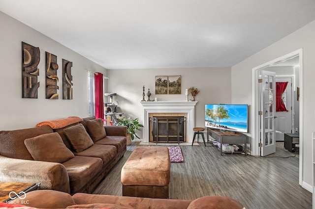 living area featuring wood finished floors and a tile fireplace