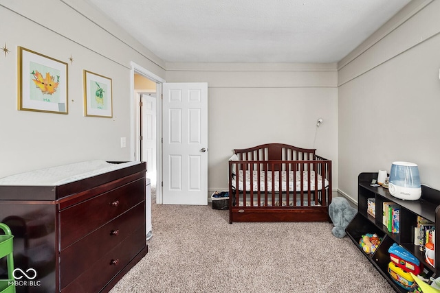 carpeted bedroom with a nursery area