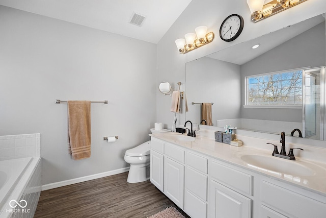 full bath featuring lofted ceiling, a bath, and a sink