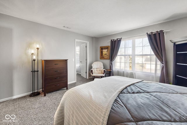 bedroom featuring visible vents, baseboards, and carpet