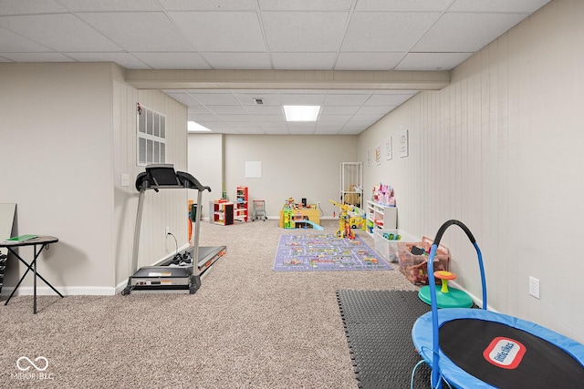 recreation room featuring carpet flooring, a paneled ceiling, and baseboards