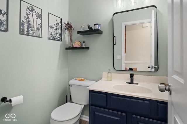 half bathroom featuring toilet and vanity