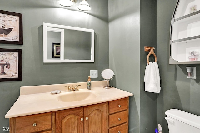 bathroom featuring toilet and vanity