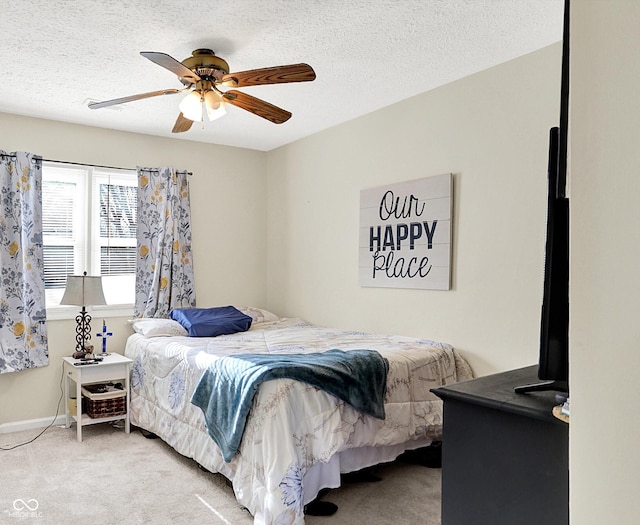 carpeted bedroom featuring ceiling fan, baseboards, and a textured ceiling