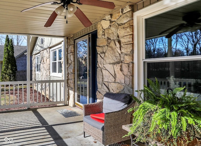 sunroom / solarium with a ceiling fan