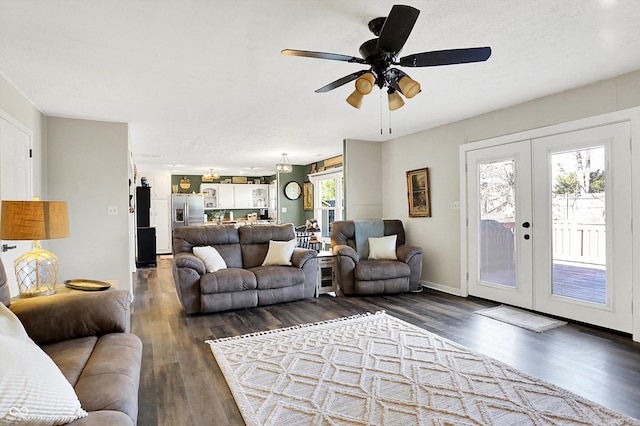 living room with dark wood-style floors, french doors, baseboards, and ceiling fan