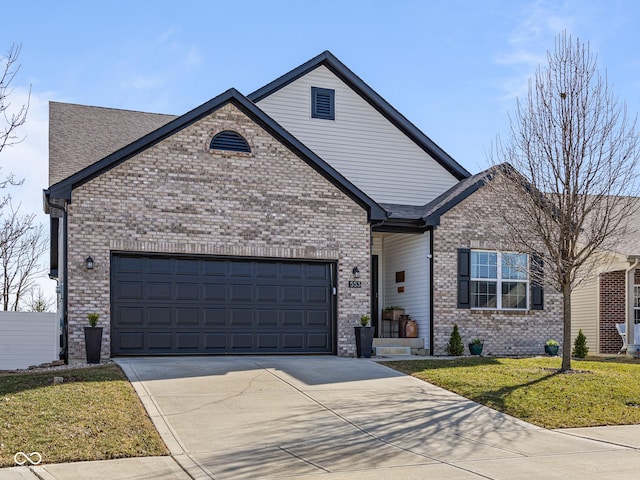 view of front of home with a front yard, brick siding, a garage, and driveway