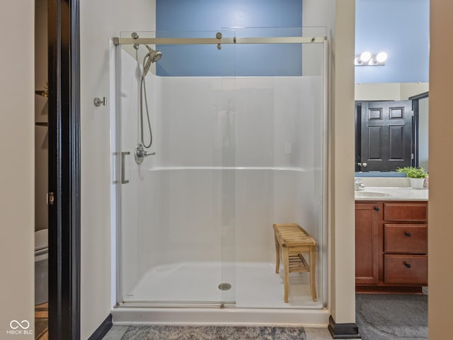 full bath featuring a stall shower and vanity