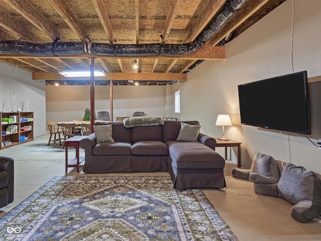 living area with unfinished concrete flooring