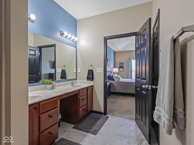 full bathroom with a sink, a textured ceiling, ensuite bathroom, and double vanity