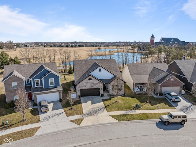 view of front of house featuring a garage, driveway, and a front lawn