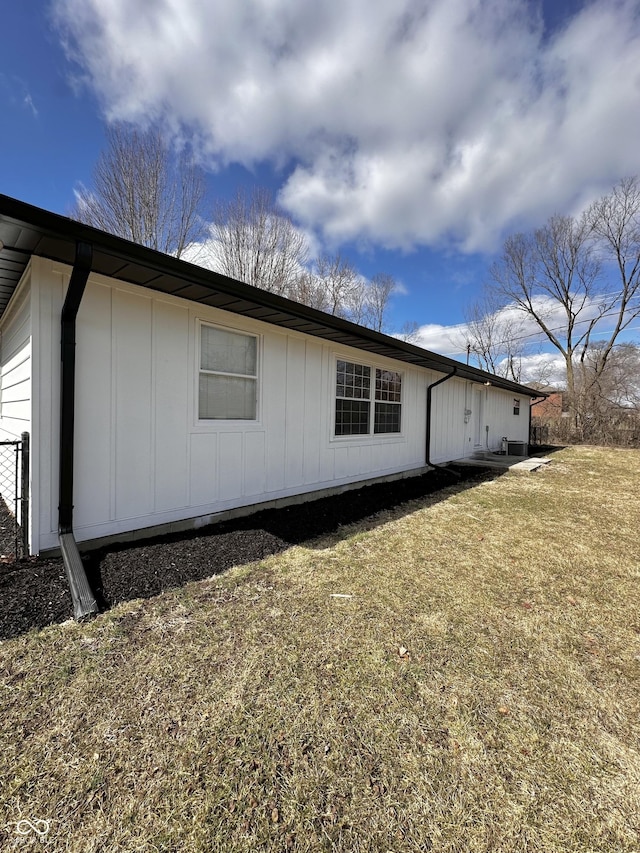 view of side of home featuring a lawn