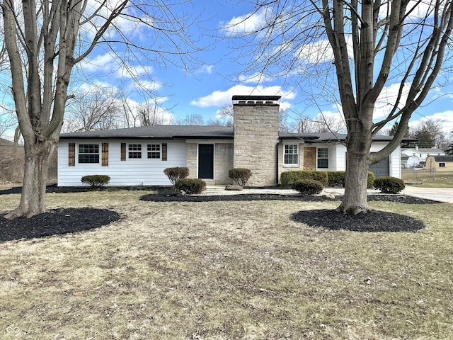 view of front facade with a garage and a chimney