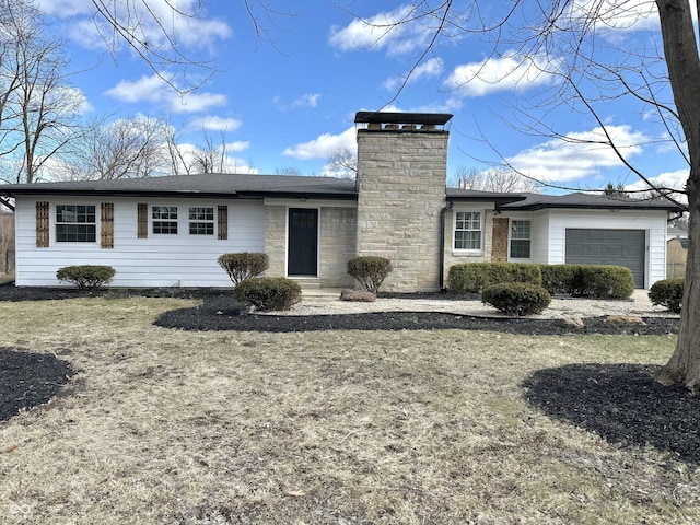 single story home featuring a chimney and a garage