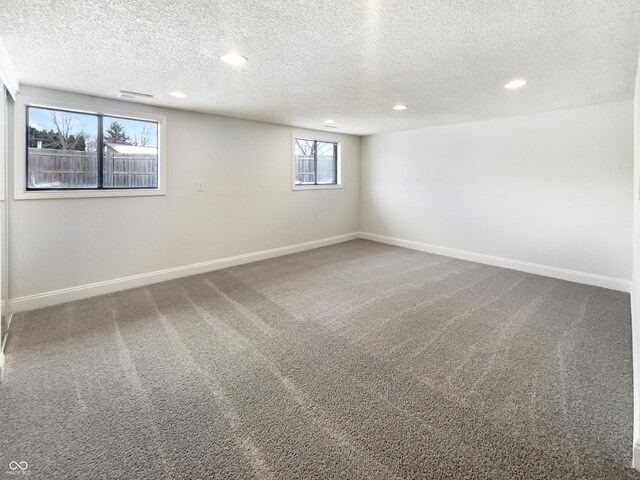 carpeted empty room featuring recessed lighting, baseboards, and a textured ceiling