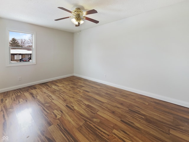 spare room featuring baseboards, a textured ceiling, wood finished floors, and a ceiling fan