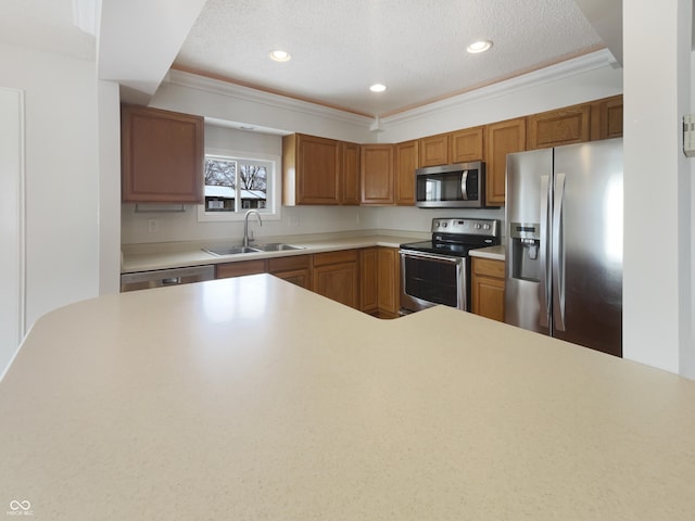 kitchen featuring light countertops, recessed lighting, appliances with stainless steel finishes, and a sink