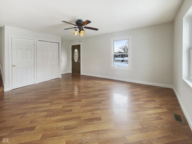 unfurnished bedroom with visible vents, ceiling fan, baseboards, light wood-type flooring, and a closet