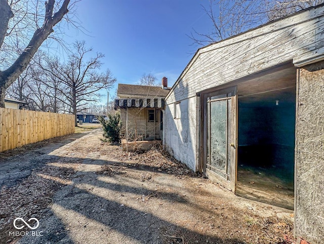 view of home's exterior with fence