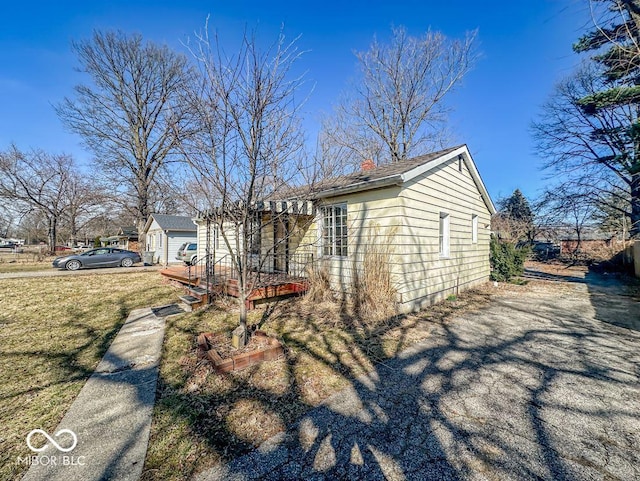 view of home's exterior with a deck and a yard