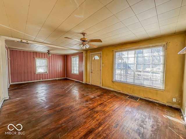 foyer entrance with hardwood / wood-style flooring, baseboards, and visible vents