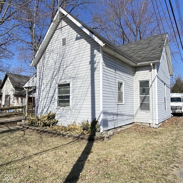 view of side of property with a yard