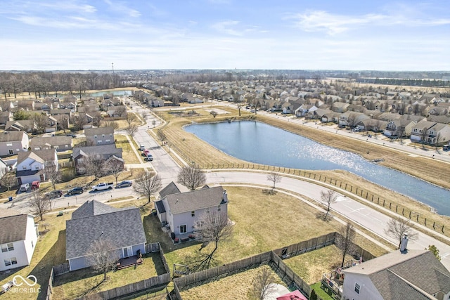 birds eye view of property with a water view and a residential view