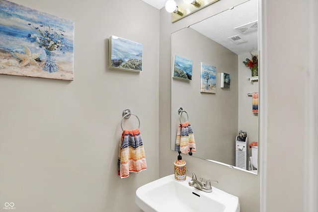 bathroom featuring a sink and visible vents