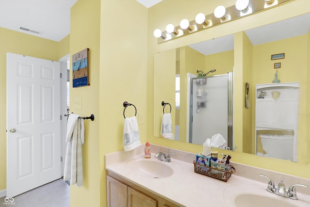 full bathroom with double vanity, visible vents, a shower stall, and a sink