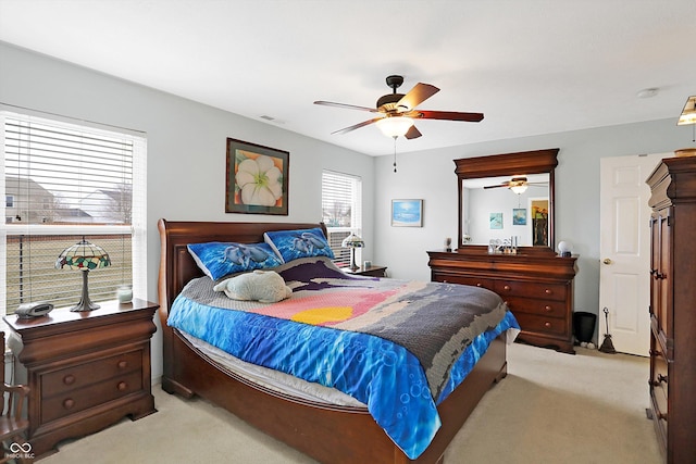 bedroom featuring ceiling fan, visible vents, and light carpet