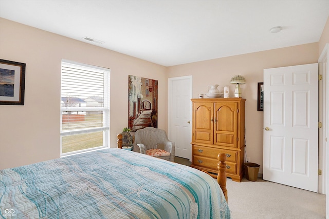 bedroom with light carpet and visible vents