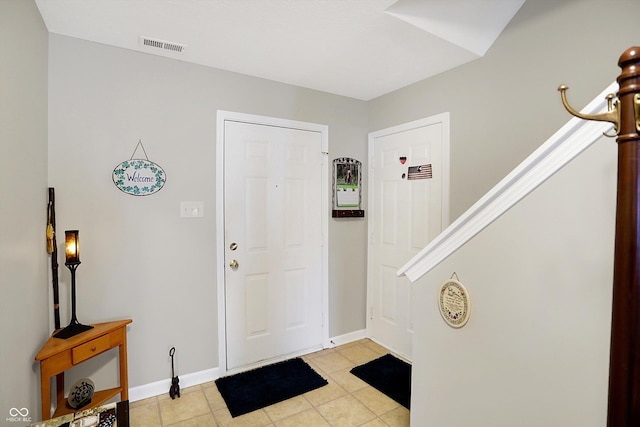 foyer with visible vents, baseboards, and light tile patterned flooring