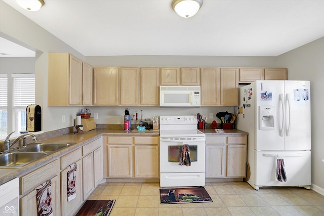 kitchen featuring light brown cabinetry, light countertops, light tile patterned floors, white appliances, and a sink