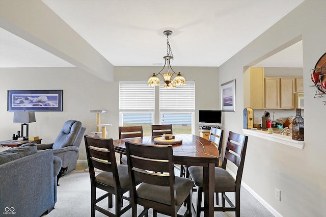 dining area featuring a chandelier, light carpet, and baseboards