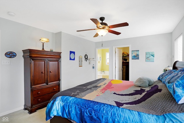 bedroom with baseboards, light carpet, ensuite bath, and ceiling fan