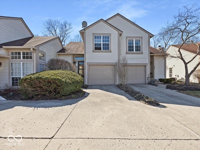 traditional-style home featuring an attached garage and driveway