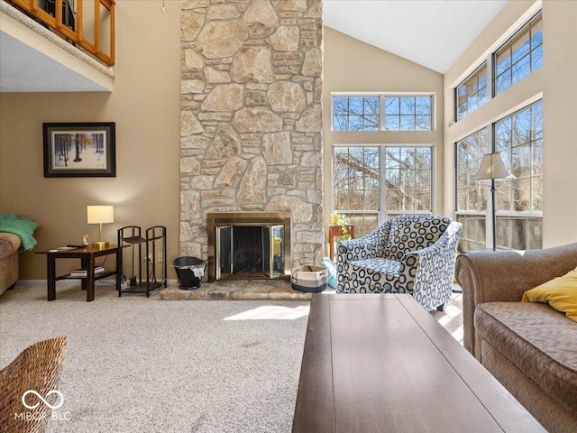 living area featuring a stone fireplace, baseboards, carpet floors, and high vaulted ceiling