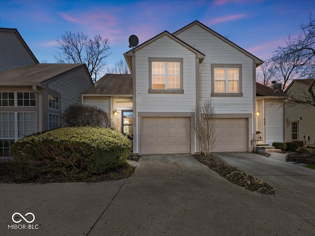 view of front of house with concrete driveway and an attached garage