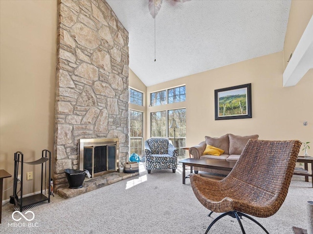 living area featuring carpet flooring, high vaulted ceiling, a fireplace, and a textured ceiling