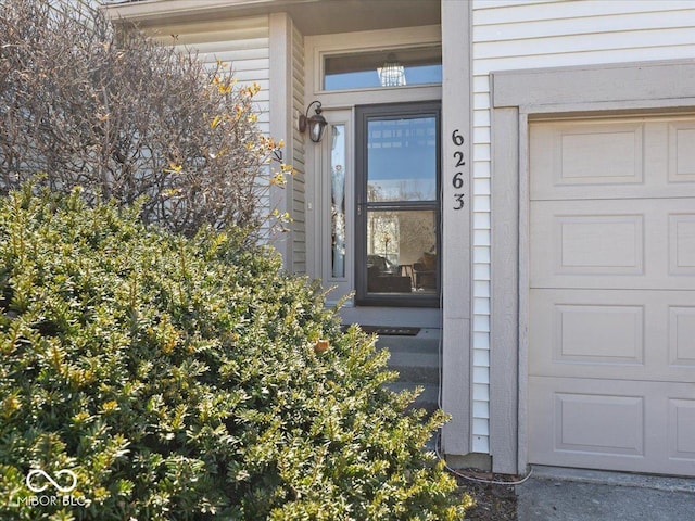 view of exterior entry with a garage