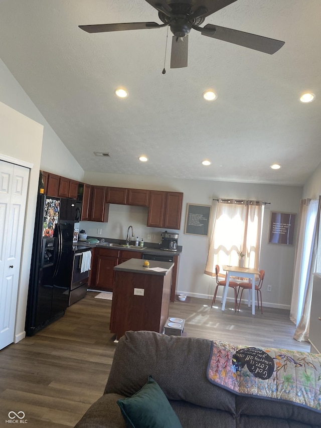 living area featuring recessed lighting, dark wood-type flooring, and vaulted ceiling