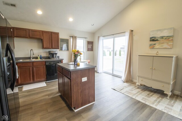 12145 Bubbling Brook Dr Unit 600, Fishers, IN 46038 - kitchen featuring a sink, black appliances, wood finished floors, a kitchen island, and recessed lighting