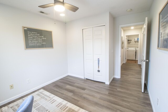 12145 Bubbling Brook Dr Unit 600, Fishers, IN 46038 - unfurnished bedroom featuring washing machine and dryer, wood finished floors, baseboards, a closet, and a ceiling fan