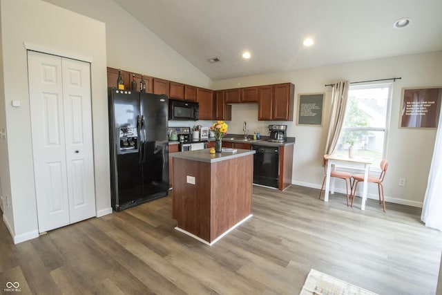 12145 Bubbling Brook Dr Unit 600, Fishers, IN 46038 - kitchen featuring black appliances, wood finished floors, a center island, baseboards, and a sink