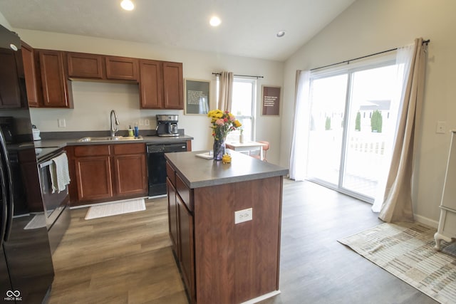 12145 Bubbling Brook Dr Unit 600, Fishers, IN 46038 - kitchen featuring a sink, dishwasher, vaulted ceiling, wood finished floors, and a kitchen island