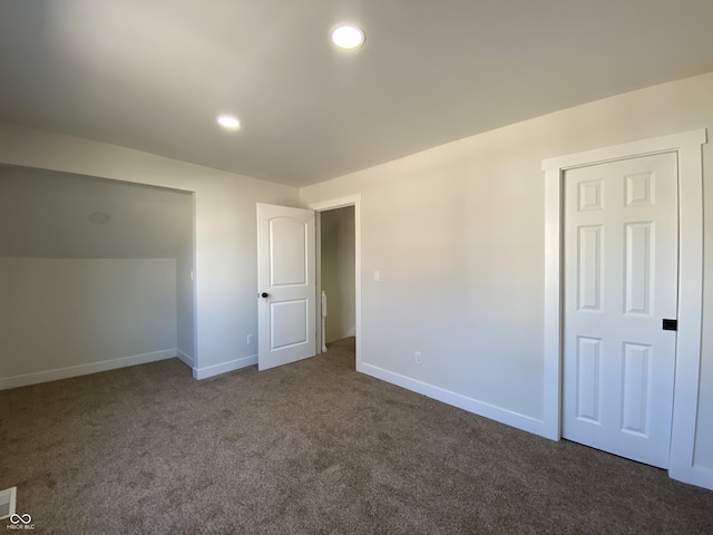 unfurnished bedroom with recessed lighting, baseboards, and dark colored carpet